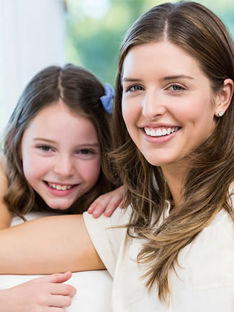 Woman with her daughter, both smiling