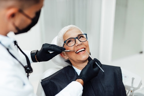 older woman smiling in dentist chair