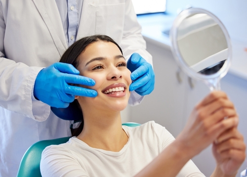 woman admiring her smile after dental treatment