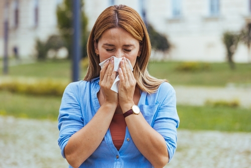 woman sneezing